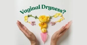 Vaginal Dryness? Yellow and pink flowers arranged in the shape of the female reproductive system, held between two cupped hands